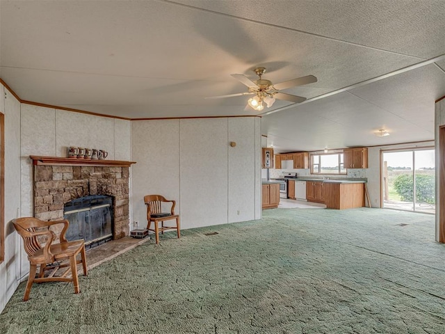 11924 W County Rd 74, Crescent, OK 73028 - living area with light carpet, a ceiling fan, a stone fireplace, and vaulted ceiling
