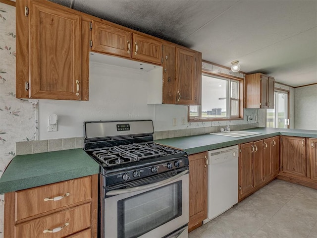 11924 W County Rd 74, Crescent, OK 73028 - kitchen featuring stainless steel gas range, dishwasher, and brown cabinetry