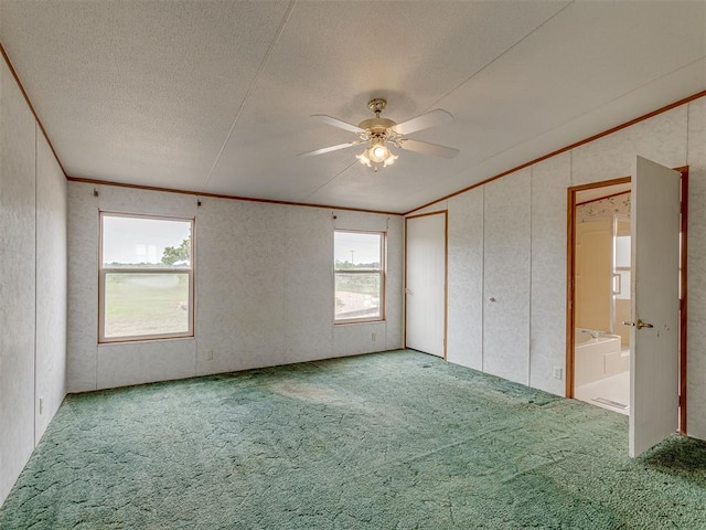 11924 W County Rd 74, Crescent, OK 73028 - unfurnished bedroom featuring carpet, vaulted ceiling, a textured ceiling, ceiling fan, and crown molding