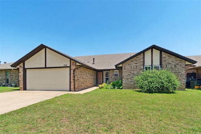 708 Cactus Ct, Yukon, OK 73099 - mid-century home featuring an attached garage, a front lawn, driveway, and brick siding