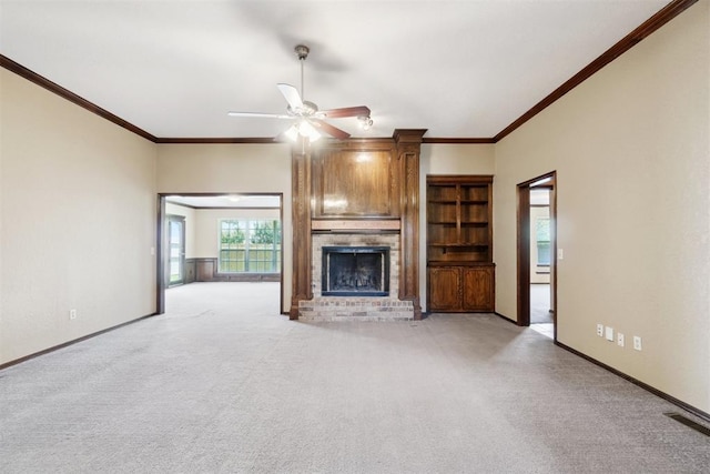 708 Cactus Ct, Yukon, OK 73099 - unfurnished living room with a brick fireplace, a ceiling fan, light carpet, and crown molding