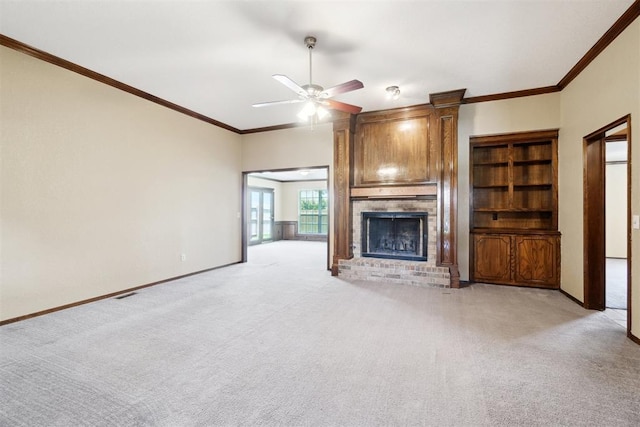 708 Cactus Ct, Yukon, OK 73099 - unfurnished living room with a fireplace, light colored carpet, a ceiling fan, and ornamental molding