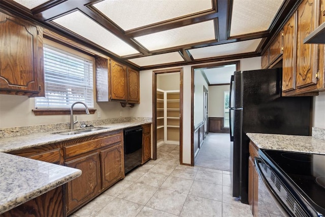 708 Cactus Ct, Yukon, OK 73099 - kitchen featuring black dishwasher, range with electric cooktop, wall chimney range hood, light tile patterned flooring, and light carpet