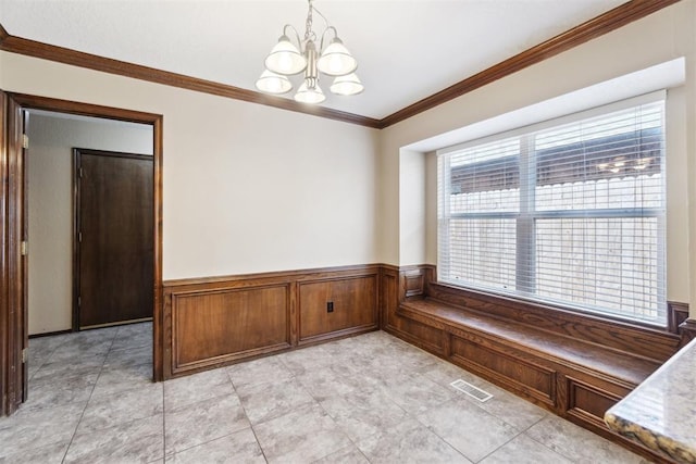 708 Cactus Ct, Yukon, OK 73099 - unfurnished dining area with a chandelier, ornamental molding, and wainscoting