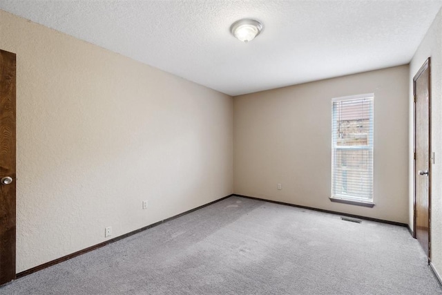 708 Cactus Ct, Yukon, OK 73099 - empty room with carpet flooring, a textured ceiling, and a textured wall