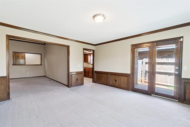 708 Cactus Ct, Yukon, OK 73099 - carpeted empty room with a wainscoted wall and ornamental molding