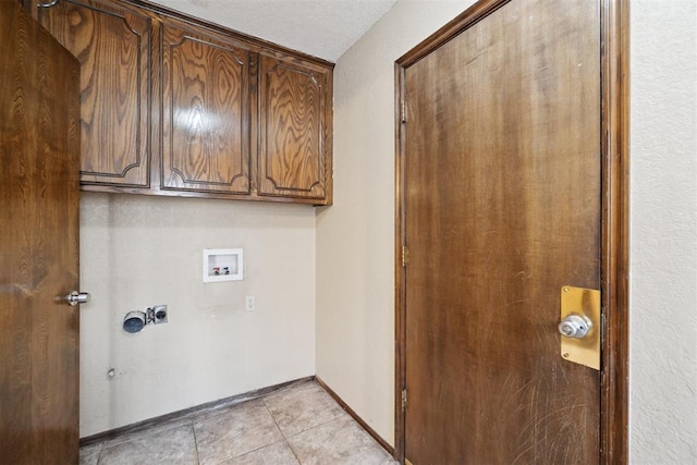 708 Cactus Ct, Yukon, OK 73099 - laundry area with washer hookup, cabinet space, and light tile patterned floors