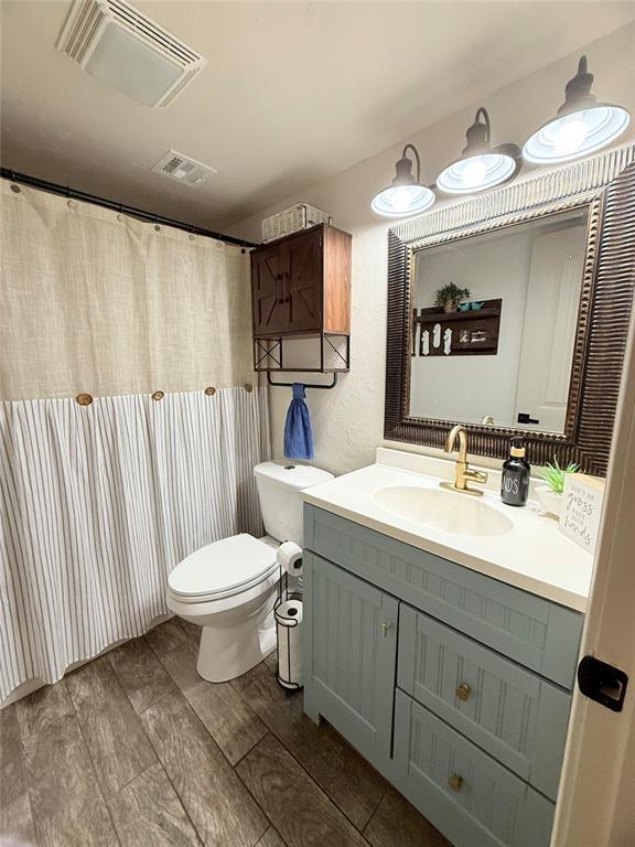 1616 NE 5th St, Moore, OK 73160 - bathroom with vanity and wood finished floors