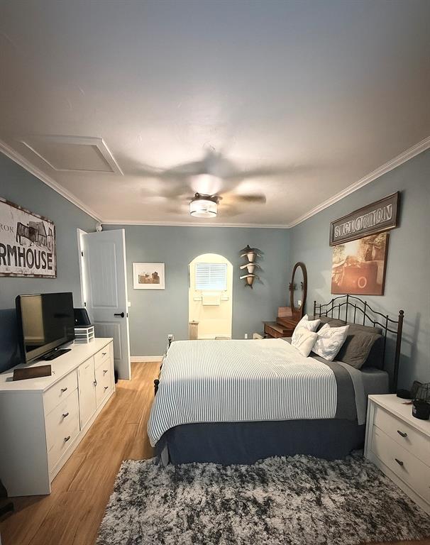 1616 NE 5th St, Moore, OK 73160 - bedroom featuring crown molding, light wood-style flooring, and a ceiling fan