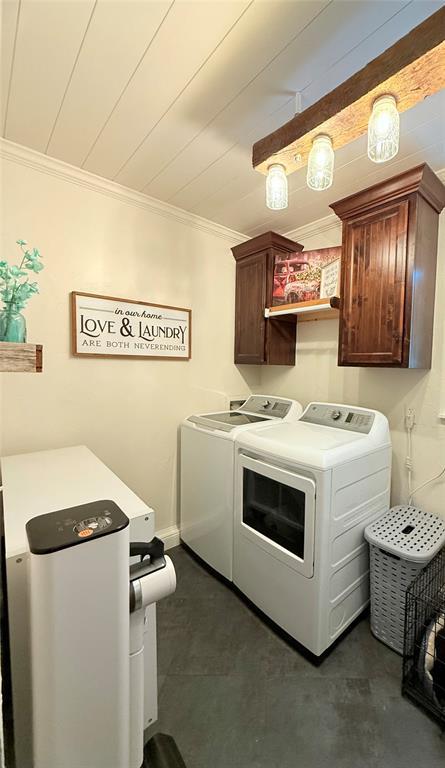 1616 NE 5th St, Moore, OK 73160 - laundry room featuring separate washer and dryer, crown molding, and cabinet space