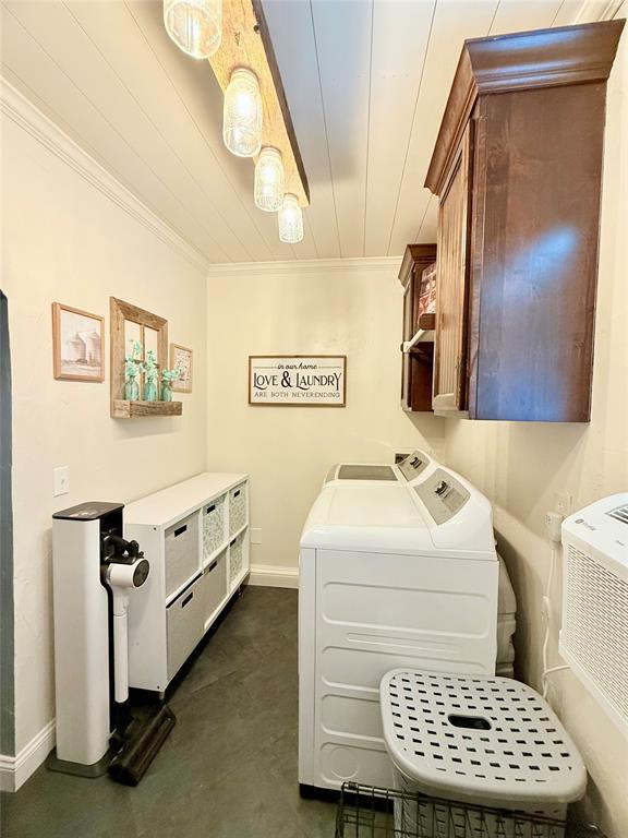 1616 NE 5th St, Moore, OK 73160 - laundry area with washing machine and clothes dryer, crown molding, cabinet space, and wood ceiling