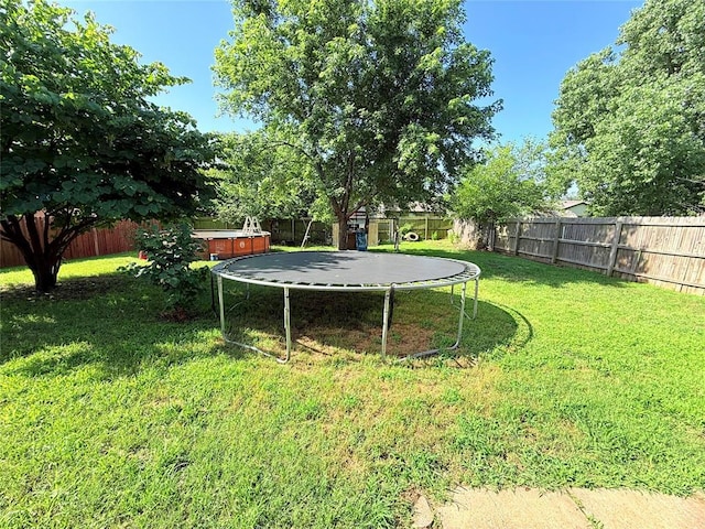 1616 NE 5th St, Moore, OK 73160 - fenced backyard featuring a hot tub and a trampoline