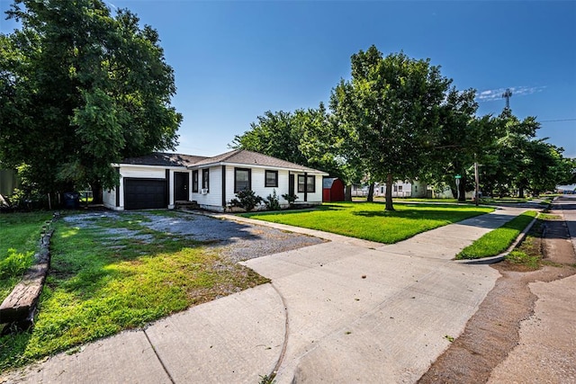 406 SW 4th St, Tuttle, OK 73089 - ranch-style house featuring gravel driveway, a front lawn, and a garage