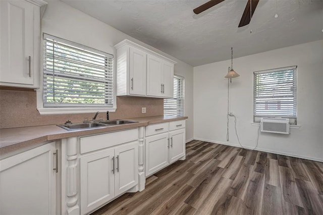 406 SW 4th St, Tuttle, OK 73089 - kitchen with white cabinets, a ceiling fan, dark wood-type flooring, and light countertops