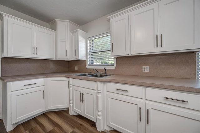 406 SW 4th St, Tuttle, OK 73089 - kitchen featuring dark wood-style flooring, white cabinetry, decorative backsplash, and light countertops