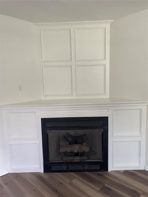 406 SW 4th St, Tuttle, OK 73089 - detailed view of a fireplace and wood finished floors