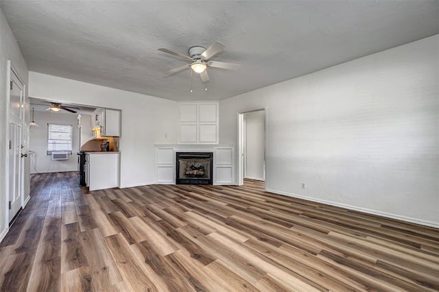 406 SW 4th St, Tuttle, OK 73089 - unfurnished living room featuring a ceiling fan, dark wood-style flooring, and a fireplace