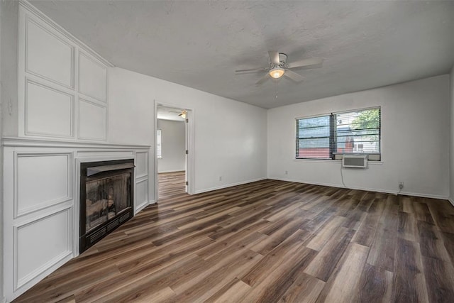 406 SW 4th St, Tuttle, OK 73089 - unfurnished living room with a ceiling fan, dark wood-type flooring, and a fireplace