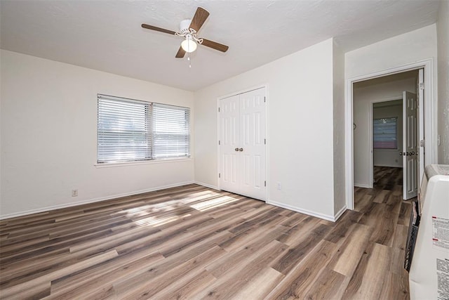 406 SW 4th St, Tuttle, OK 73089 - unfurnished bedroom with wood finished floors, a closet, and a ceiling fan
