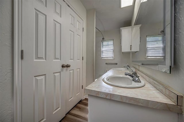 406 SW 4th St, Tuttle, OK 73089 - full bathroom featuring double vanity, wood finished floors, and a shower