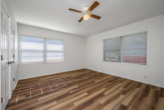 406 SW 4th St, Tuttle, OK 73089 - spare room featuring a ceiling fan, wood finished floors, and healthy amount of natural light