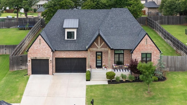 5017 Yale Bridge Ct, Edmond, OK 73034 - view of front of house with brick siding, a trampoline, a shingled roof, concrete driveway, and an attached garage