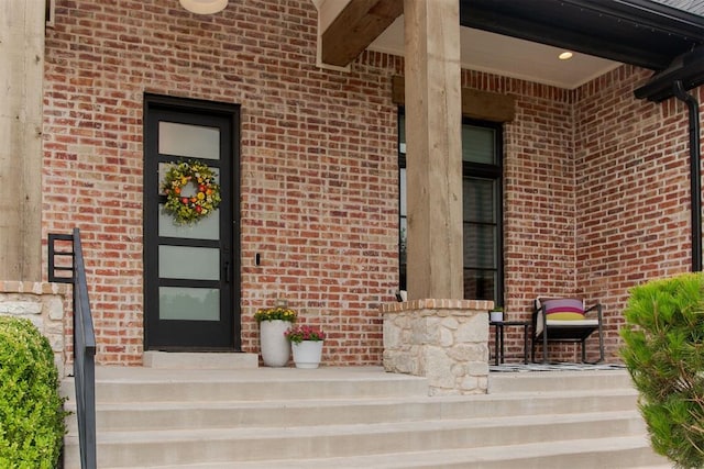 5017 Yale Bridge Ct, Edmond, OK 73034 - doorway to property featuring brick siding and a porch