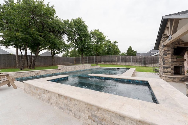 5017 Yale Bridge Ct, Edmond, OK 73034 - view of swimming pool featuring an outdoor stone fireplace, an in-ground hot tub, a fenced backyard, and a patio area
