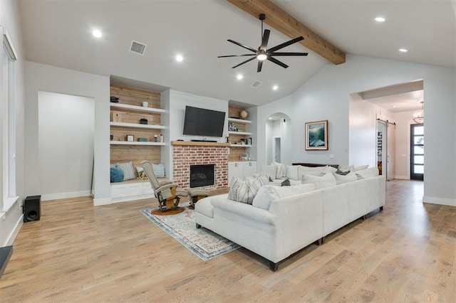 5017 Yale Bridge Ct, Edmond, OK 73034 - living area featuring a brick fireplace, arched walkways, a ceiling fan, light wood-style floors, and recessed lighting