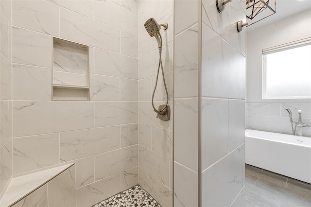 5017 Yale Bridge Ct, Edmond, OK 73034 - bathroom featuring a tile shower, a bath, and tile walls