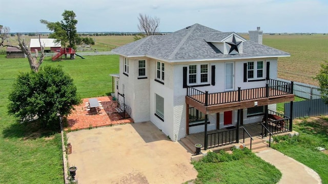 15274 US Highway 283, Blair, OK 73526 - view of front facade featuring a patio, a chimney, a front yard, a deck, and roof with shingles