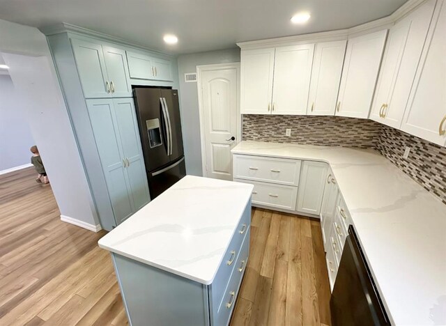 15274 US Highway 283, Blair, OK 73526 - kitchen with stainless steel fridge, light wood-style flooring, tasteful backsplash, recessed lighting, and light stone countertops
