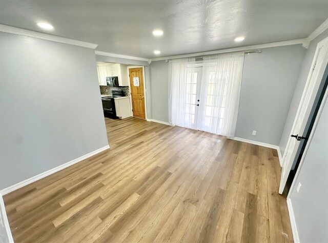15274 US Highway 283, Blair, OK 73526 - unfurnished living room with crown molding, light wood finished floors, and recessed lighting