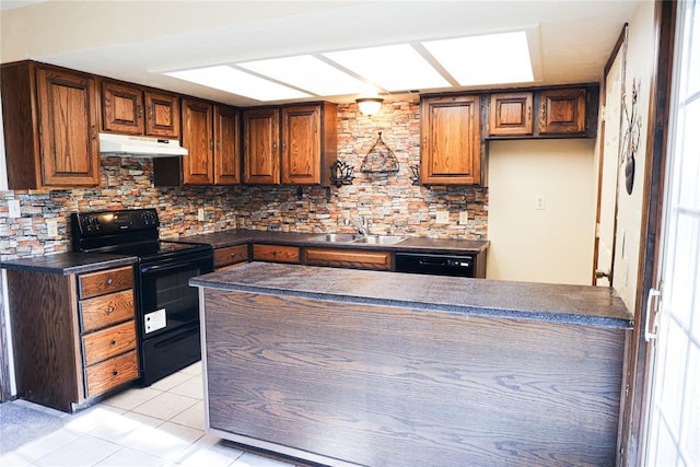 3823 N Harvard Ave Unit 12, Oklahoma City, OK 73122 - kitchen featuring black appliances, under cabinet range hood, dark countertops, and tasteful backsplash