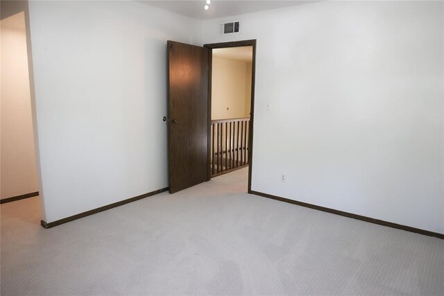 3823 N Harvard Ave Unit 12, Oklahoma City, OK 73122 - spare room featuring light carpet and baseboards