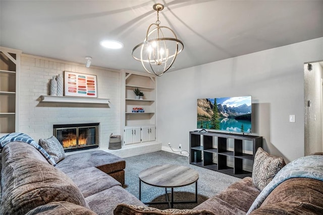 1713 Shadow Ct, Edmond, OK 73013 - living room featuring carpet floors, built in features, a fireplace, and a chandelier