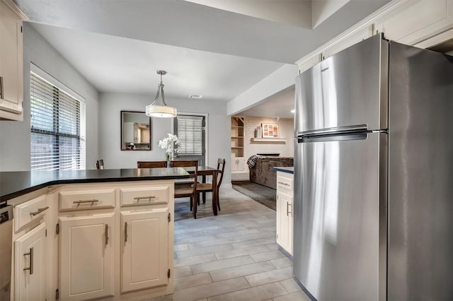 1713 Shadow Ct, Edmond, OK 73013 - kitchen featuring appliances with stainless steel finishes, a peninsula, dark countertops, hanging light fixtures, and open floor plan