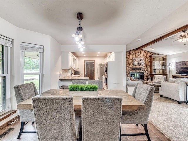 8001 84th St, Noble, OK 73068 - dining space with a fireplace, light wood-type flooring, and ceiling fan