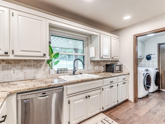 8001 84th St, Noble, OK 73068 - kitchen featuring appliances with stainless steel finishes, washer and clothes dryer, white cabinets, backsplash, and light wood-type flooring