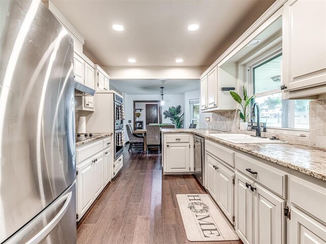 8001 84th St, Noble, OK 73068 - kitchen featuring appliances with stainless steel finishes, backsplash, a peninsula, white cabinetry, and recessed lighting