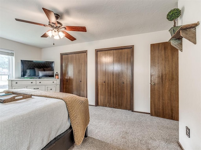 8001 84th St, Noble, OK 73068 - bedroom with light colored carpet, two closets, and ceiling fan