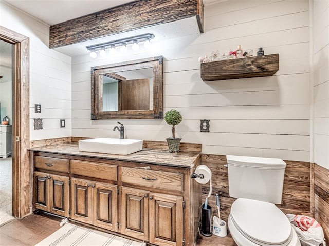8001 84th St, Noble, OK 73068 - half bathroom featuring wood walls, vanity, and wood finished floors
