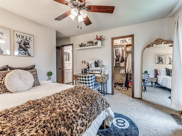 8001 84th St, Noble, OK 73068 - bedroom with carpet, ceiling fan, connected bathroom, a walk in closet, and a closet