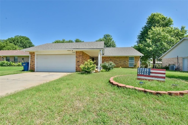 1107 W Windsor Way, Mustang, OK 73064 - view of front facade with brick siding, a garage, concrete driveway, and a front lawn