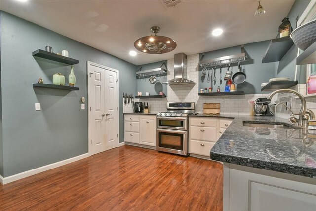 1107 W Windsor Way, Mustang, OK 73064 - kitchen with wall chimney range hood, range with two ovens, open shelves, backsplash, and dark wood-type flooring