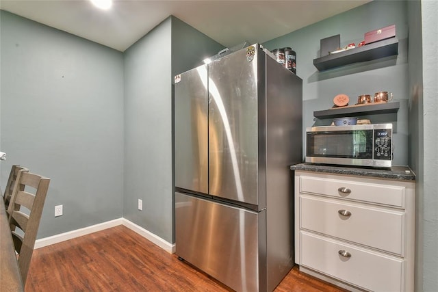 1107 W Windsor Way, Mustang, OK 73064 - kitchen with appliances with stainless steel finishes, dark wood finished floors, open shelves, and white cabinets