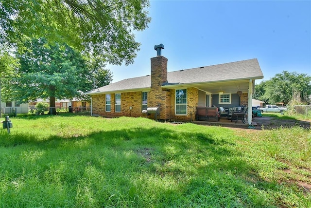 1107 W Windsor Way, Mustang, OK 73064 - back of house with a chimney, a patio area, outdoor lounge area, and brick siding