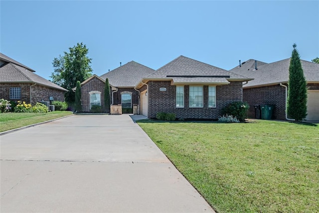 12037 Ashford Dr, Yukon, OK 73099 - french country home featuring a garage, brick siding, concrete driveway, a front lawn, and a shingled roof