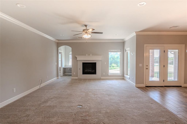 12037 Ashford Dr, Yukon, OK 73099 - unfurnished living room with arched walkways, ceiling fan, crown molding, a fireplace, and recessed lighting