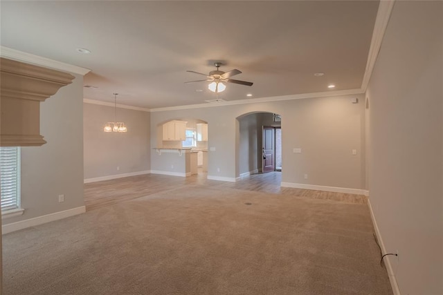 12037 Ashford Dr, Yukon, OK 73099 - unfurnished living room with light carpet, arched walkways, ceiling fan, ornamental molding, and recessed lighting